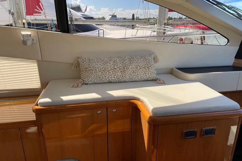 Slide: The Image of Interior seating area of 2009 Sunseeker Predator 62 yacht with cushion and window view. - 19