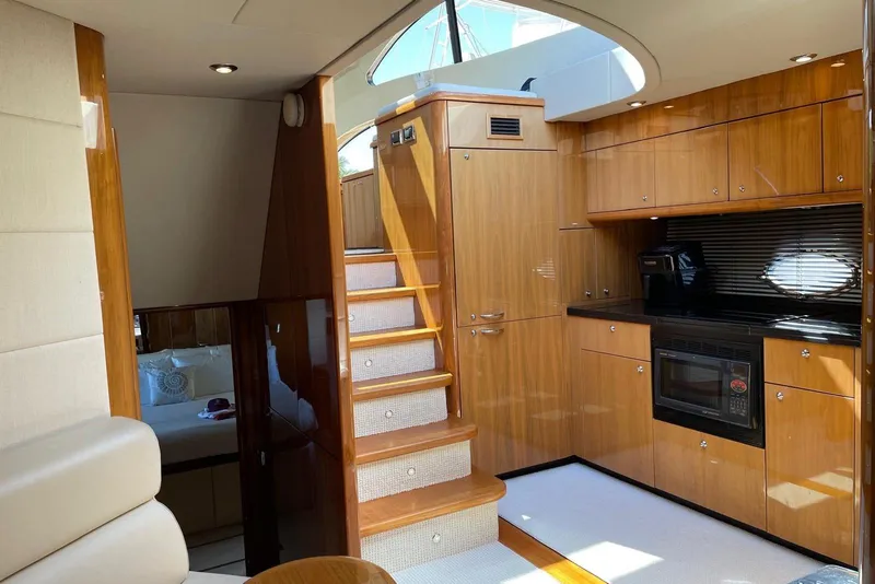Slide: The Image of Luxurious interior of 2009 Sunseeker Predator 62 yacht with wooden cabinetry and modern kitchen. - 21