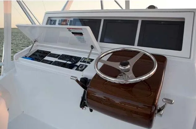 Slide: The Image of Manufacturer Provided Image: 2013 Hatteras GT54 helm station with steering wheel and navigation screens. - 4