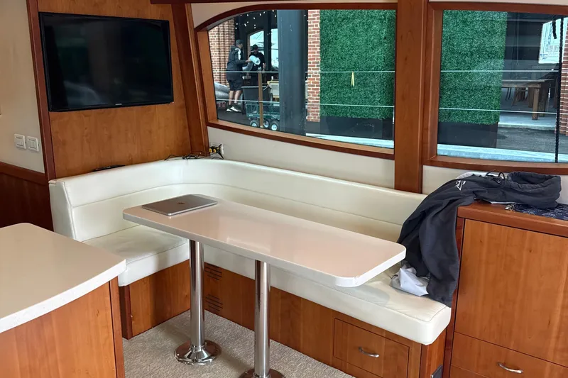 Slide: The Image of Interior of 2013 Hatteras GT54 yacht with white seating and table. - 6
