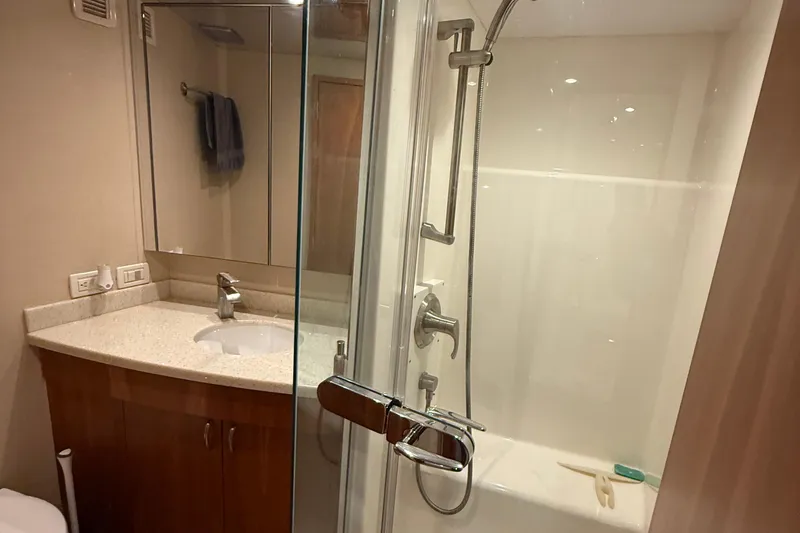 Slide: The Image of Luxurious bathroom in 2013 Hatteras GT54 yacht with modern shower and vanity. - 13