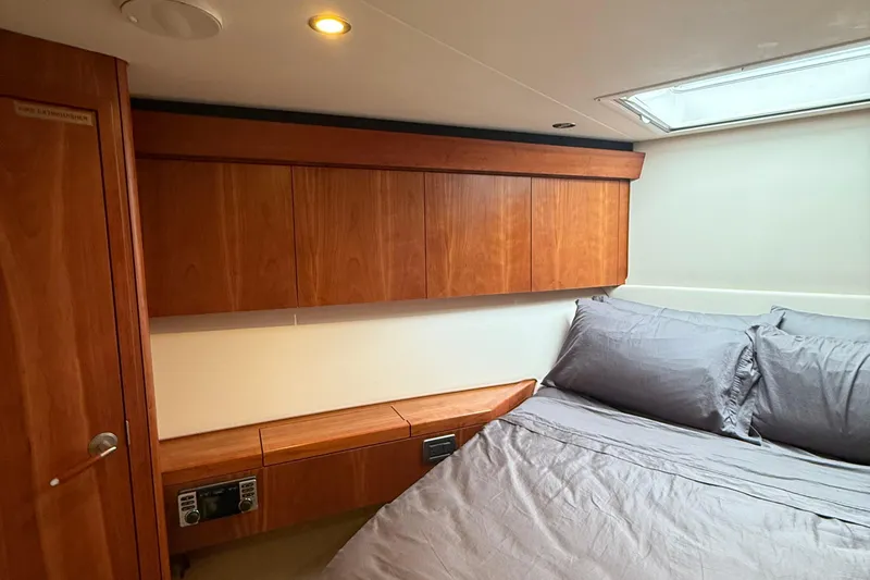 Slide: The Image of Luxurious cabin interior of 2013 Hatteras GT54 yacht with wood paneling and cozy bedding. - 15