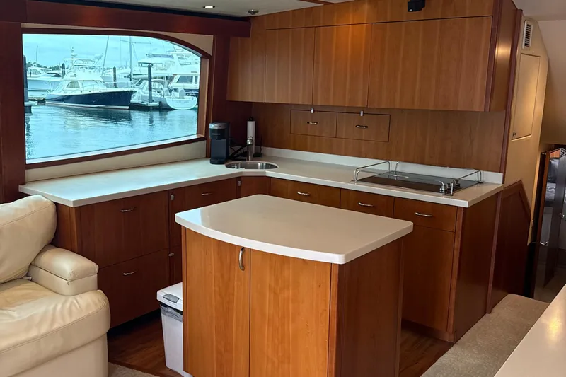 Slide: The Image of Luxurious 2013 Hatteras GT54 yacht interior with modern kitchen and marina view. - 5