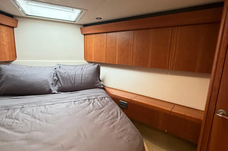 Slide: The Image of Luxurious cabin interior of 2013 Hatteras GT54 yacht with wood paneling and skylight. - 16