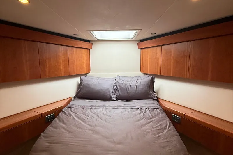Slide: The Image of Luxurious bedroom interior of 2013 Hatteras GT54 yacht with wooden cabinets and skylight. - 14