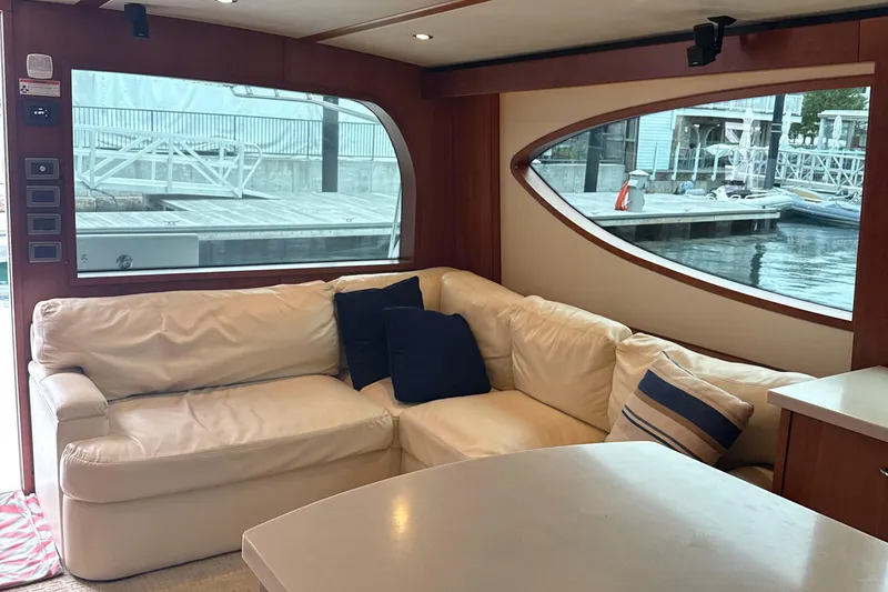Slide: The Image of Luxurious interior of 2013 Hatteras GT54 yacht with white leather seating and marina view. - 7