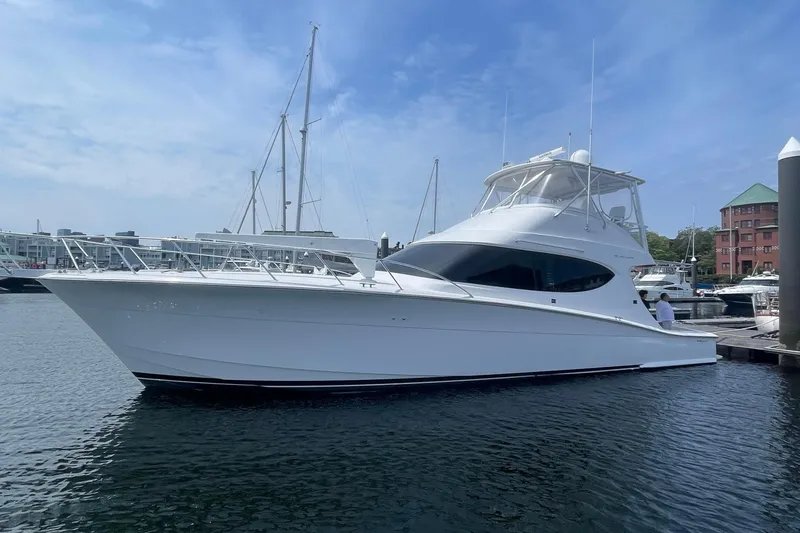 The Image of 2013 Hatteras GT54 yacht docked at marina under clear blue sky. - 0