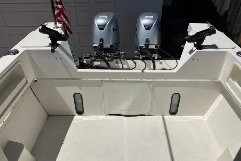Slide: The Image of 2014 C-Dory 22 Cruiser boat with dual Honda outboard motors and rod holders. - 5