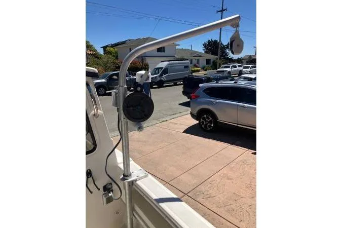 Slide: The Image of 2014 C-Dory 22 Cruiser boat with mounted equipment in a residential driveway. - 6