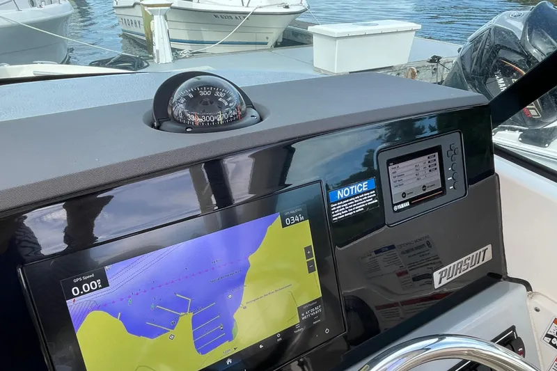 Slide: The Image of Dashboard of a 2020 Pursuit DC 235 Dual Console with navigation display and compass. - 22