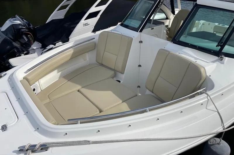 Slide: The Image of 2020 Pursuit DC 235 Dual Console boat with beige seating and Yamaha outboard motor. - 27