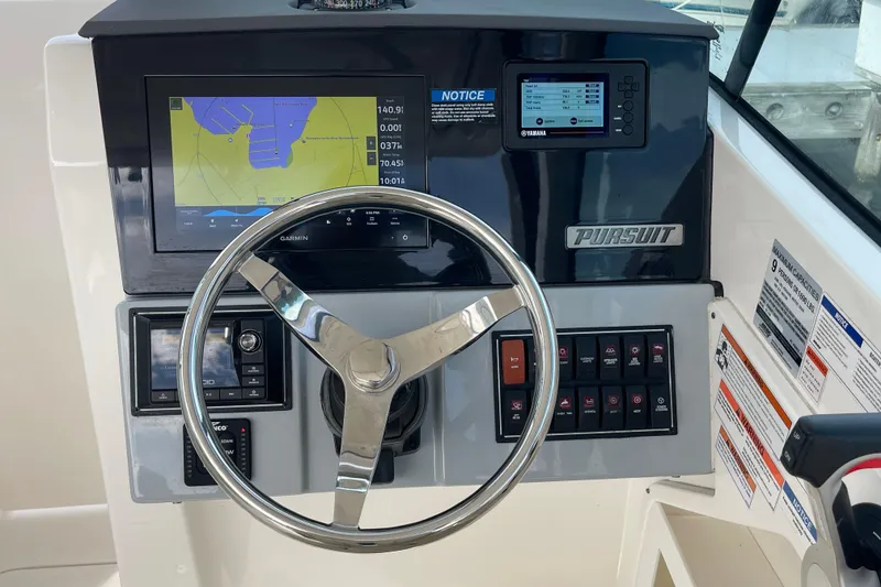 Slide: The Image of Steering console of 2020 Pursuit DC 235 Dual Console boat with navigation display. - 3