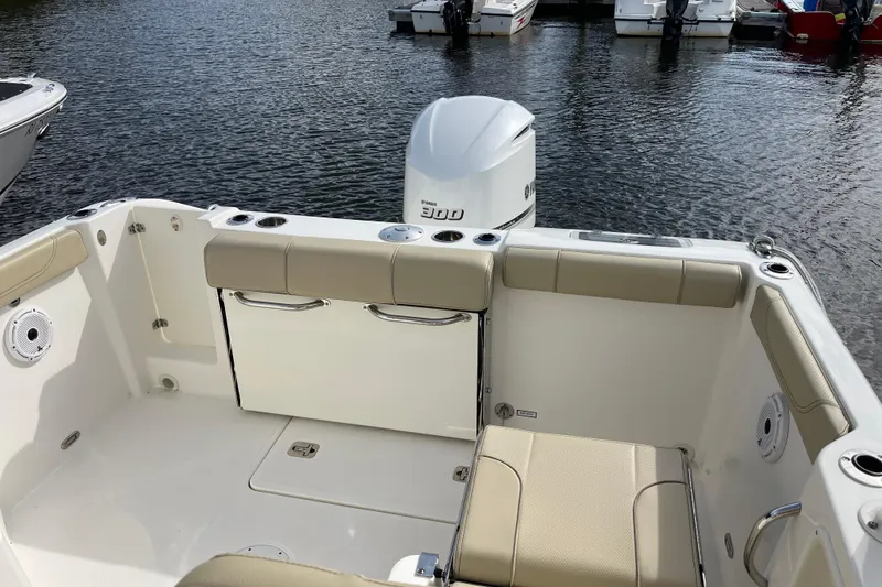Slide: The Image of 2020 Pursuit DC 235 Dual Console boat interior with seating and outboard motor. - 30