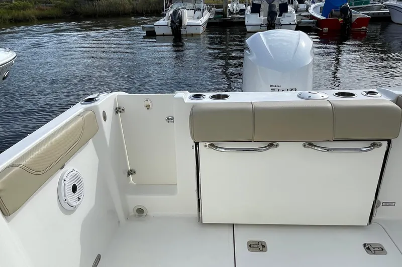 Slide: The Image of 2020 Pursuit DC 235 Dual Console boat interior with seating and water view. - 39