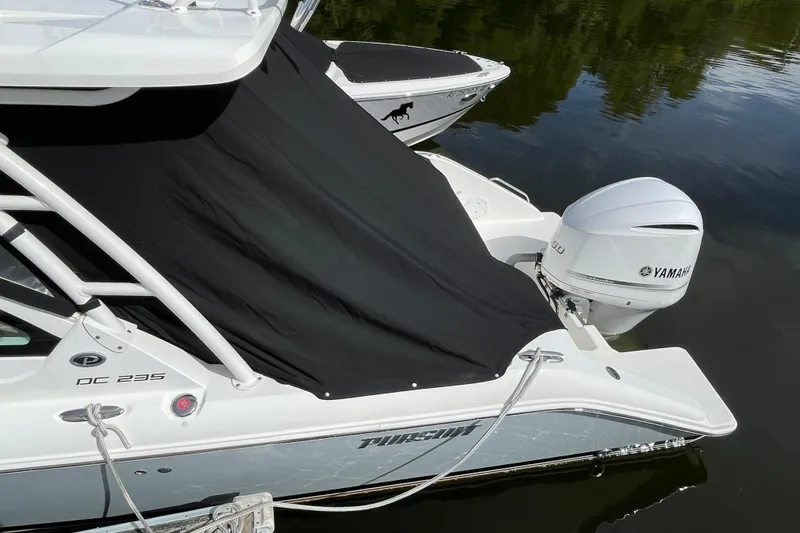 Slide: The Image of 2020 Pursuit DC 235 Dual Console boat with Yamaha outboard engine, covered and docked. - 62