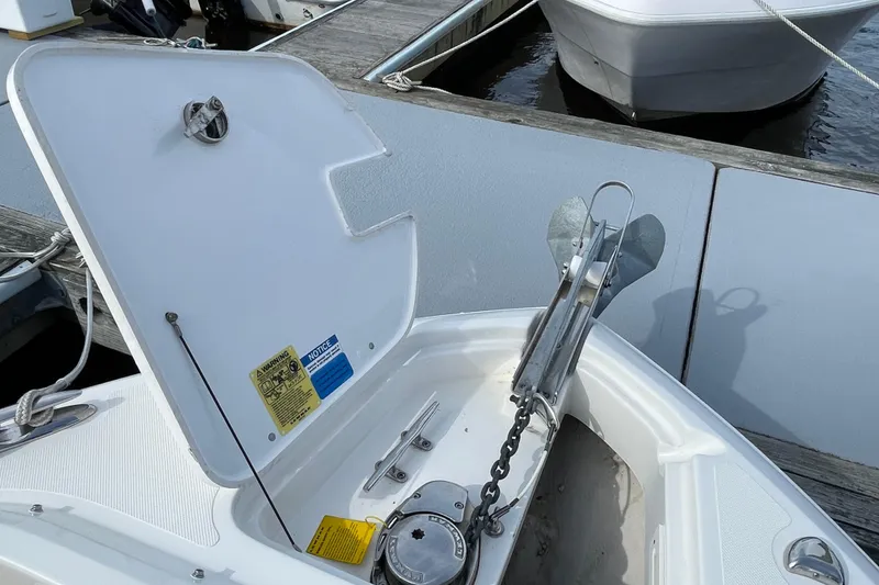 Slide: The Image of 2020 Pursuit DC 235 Dual Console boat anchor compartment at dock. - 64