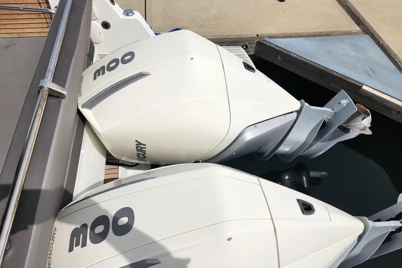 Slide: The Image of Twin Mercury outboard engines on a 2022 Beneteau Antares 11 boat at the dock. - 10