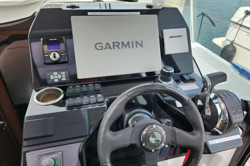 Slide: The Image of Control panel of 2022 Beneteau Antares 11 with Garmin navigation system and Mercury controls. - 11