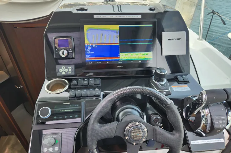 Slide: The Image of Cockpit of 2022 Beneteau Antares 11 with navigation and control systems. - 12