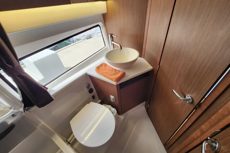 Slide: The Image of Modern bathroom in 2022 Beneteau Antares 11 yacht with wood accents and vessel sink. - 17