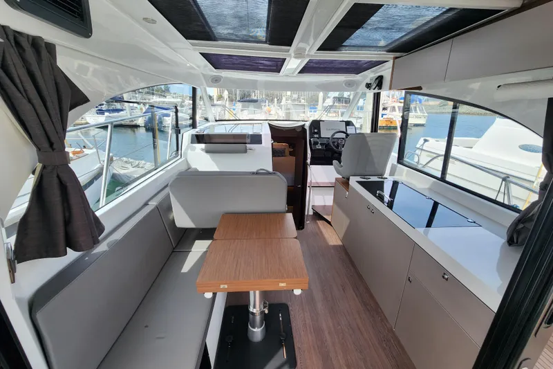 Slide: The Image of Interior of 2022 Beneteau Antares 11 yacht, featuring modern seating and helm station. - 21