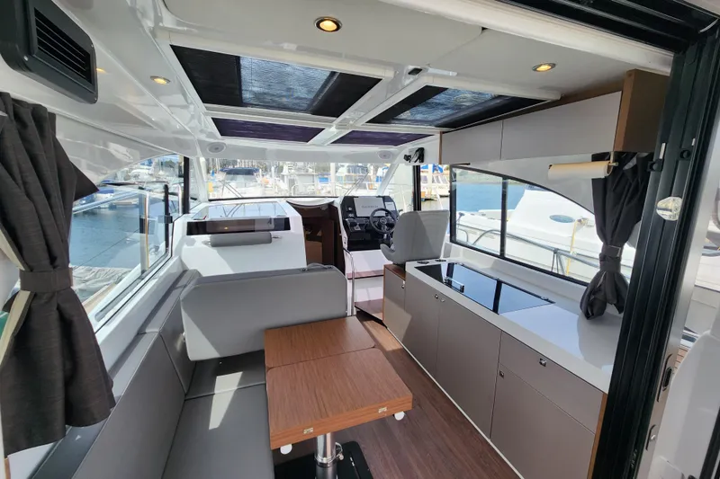Slide: The Image of Interior of 2022 Beneteau Antares 11 boat, featuring modern seating and helm. - 22