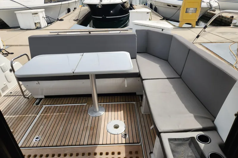 Slide: The Image of Beneteau Antares 11, 2022 model, featuring a sleek outdoor seating area with a table. - 26