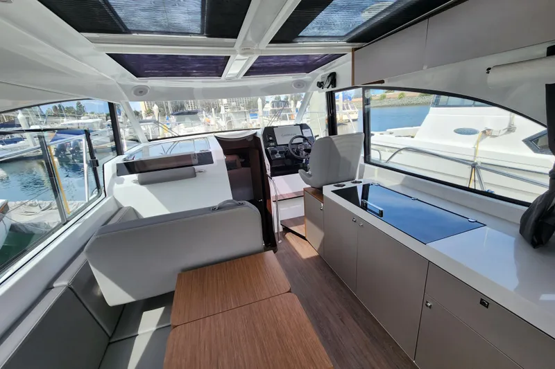 Slide: The Image of Interior of 2022 Beneteau Antares 11 yacht, featuring modern seating and navigation area. - 29