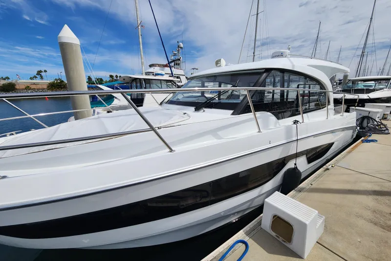 Slide: The Image of 2022 Beneteau Antares 11 docked at marina under blue sky. - 4