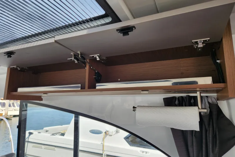 Slide: The Image of Interior storage cabinet on a 2022 Beneteau Antares 11 boat with paper towel holder. - 42