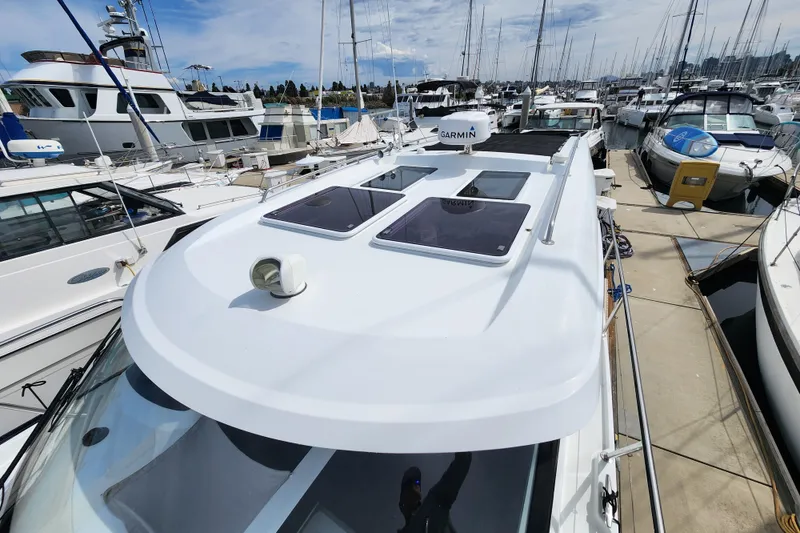 Slide: The Image of 2022 Beneteau Antares 11 docked at marina, featuring sleek design and Garmin equipment. - 9