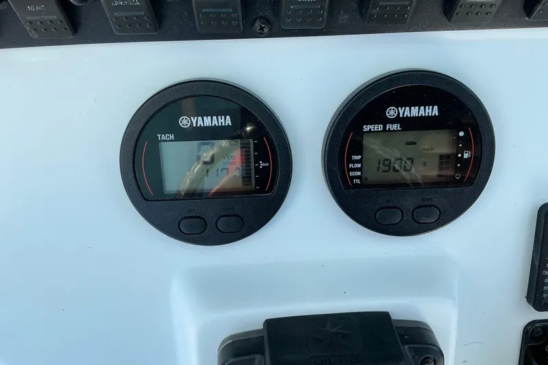 Slide: The Image of Yamaha gauges on 2019 Sea Hunt Ultra 225 boat dashboard, displaying tachometer and speed fuel. - 14