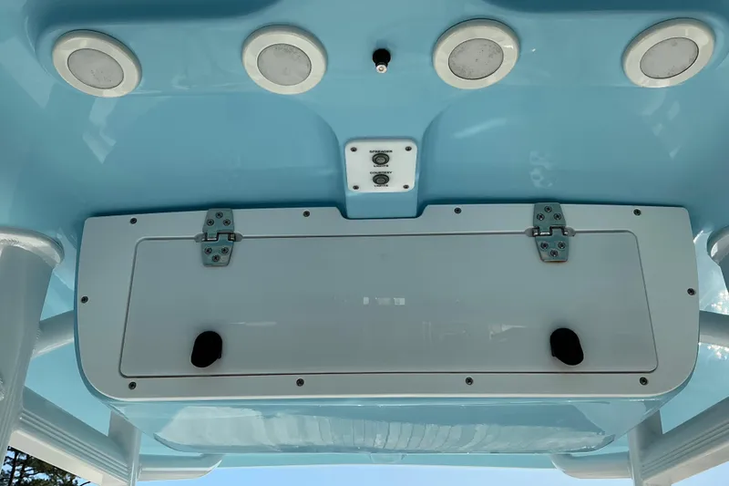 Slide: The Image of 2019 Sea Hunt Ultra 225 boat console with speakers and storage compartment. - 16