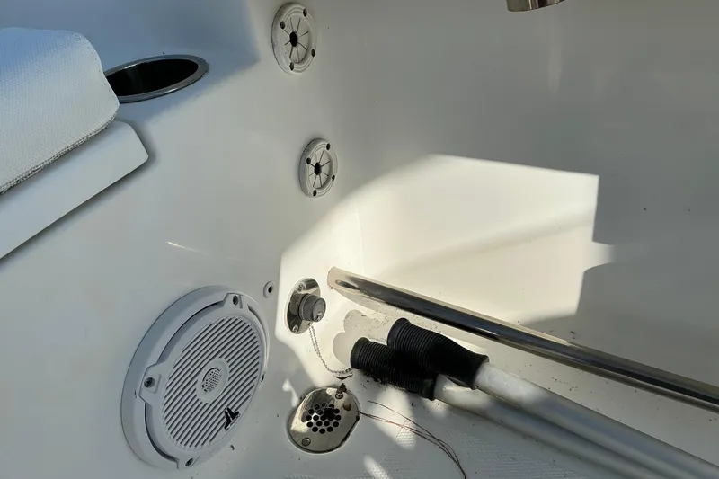 Slide: The Image of Interior view of a 2019 Sea Hunt Ultra 225 boat, featuring speakers and drainage system. - 25