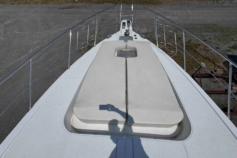 Slide: The Image of Luxury Horizon E56 yacht docked at marina, 2000 model, with scenic waterfront view. - 11