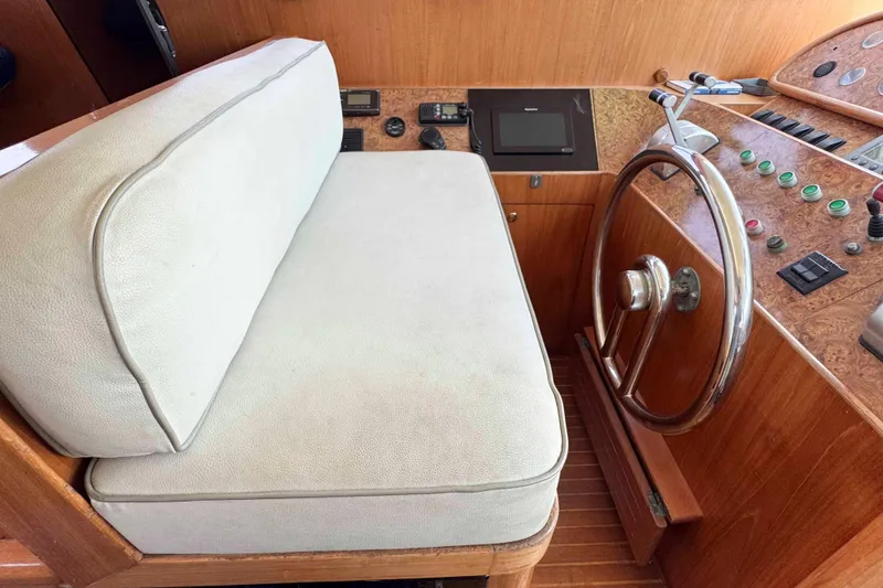 Slide: The Image of 2000 Horizon E56 yacht in harbor with white seating area. - 17