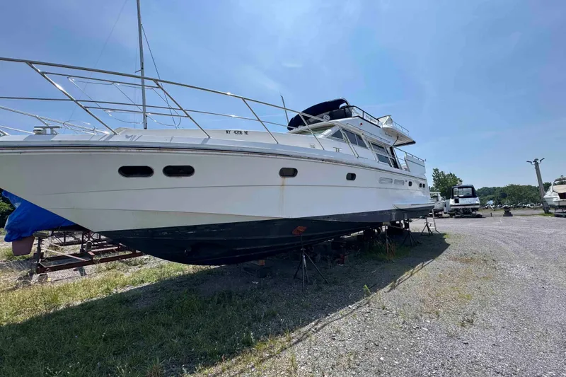 Slide: The Image of Luxury Horizon E56 yacht from 2000, docked under a clear blue sky. - 2