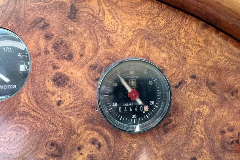 Slide: The Image of Wooden dashboard with vintage Horizon E56 gauges, showing engine hours and fuel level. - 37