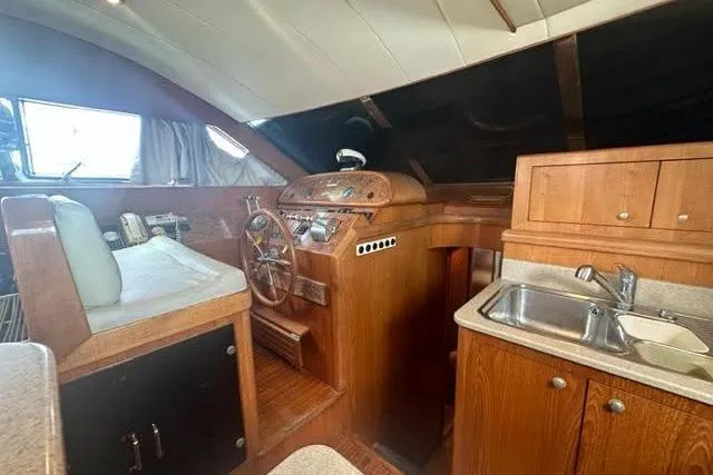 Slide: The Image of Interior of a 2000 Horizon E56 yacht with helm and kitchenette. - 38