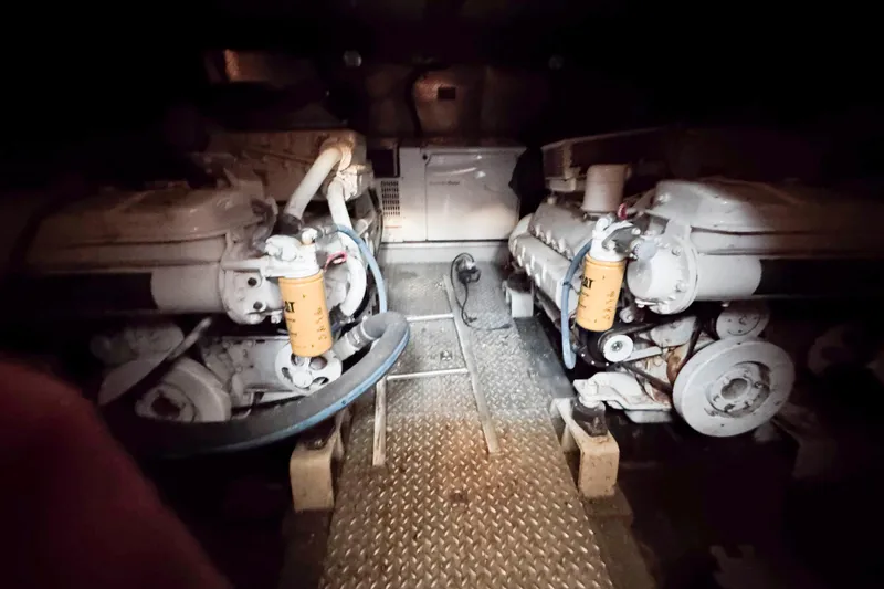 Slide: The Image of Engine room of a 2000 Horizon E56 yacht with dual engines and metal flooring. - 46