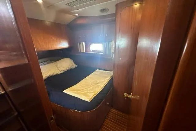 Slide: The Image of Cozy cabin interior of 2000 Horizon E56 yacht with wooden finish and bed. - 49