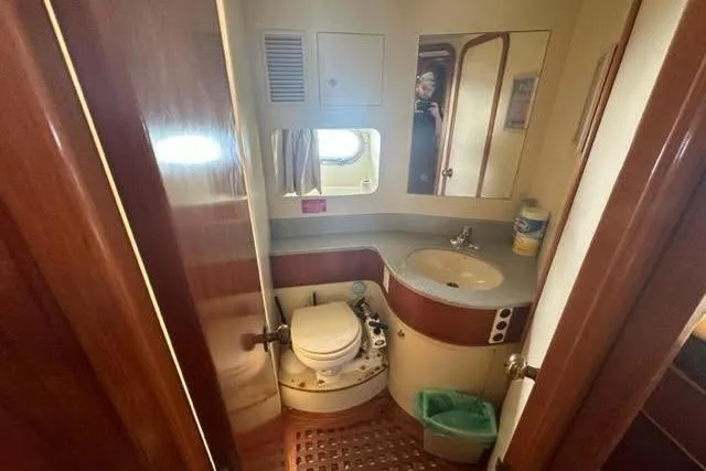 Slide: The Image of Small bathroom in 2000 Horizon E56 yacht with sink, toilet, and mirror. - 51