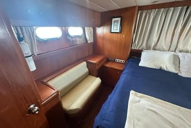 Slide: The Image of Cozy cabin interior of 2000 Horizon E56 yacht with wood paneling and blue bedding. - 59