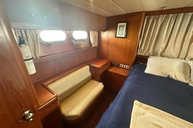 Slide: The Image of Cozy cabin interior of 2000 Horizon E56 yacht with wood paneling and porthole windows. - 61