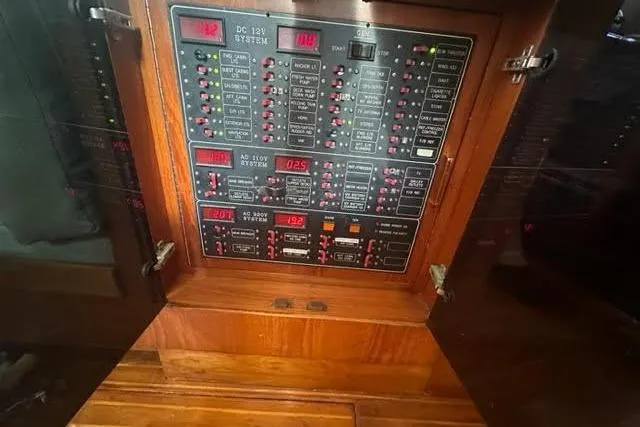 Slide: The Image of Electrical control panel inside a 2000 Horizon E56 yacht, featuring various switches and indicators. - 62