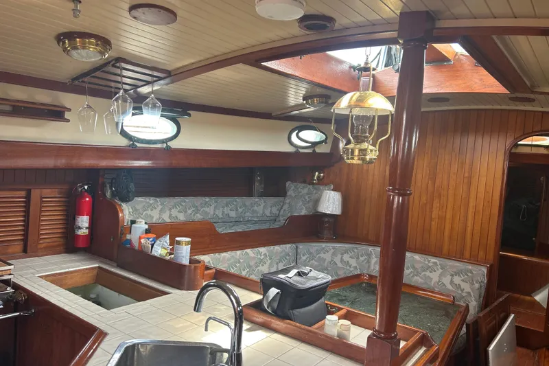 Slide: The Image of Interior of 1980 Hans Christian 43 sailboat with wooden finishes and cozy seating area. - 14