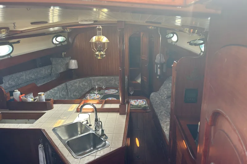 Slide: The Image of Interior of 1980 Hans Christian 43 sailboat with cozy seating and wooden finishes. - 17
