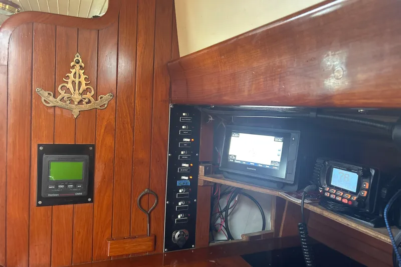 Slide: The Image of Interior of 1980 Hans Christian 43 sailboat with navigation equipment and wooden paneling. - 19