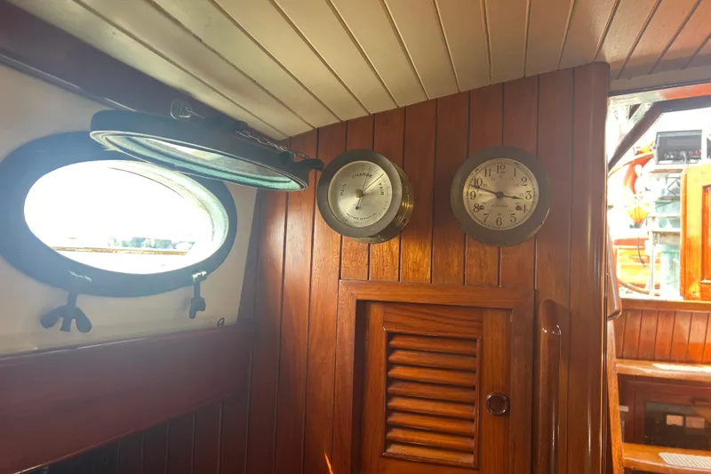 Slide: The Image of Interior of 1980 Hans Christian 43 sailboat with wooden paneling, clock, and barometer. - 20