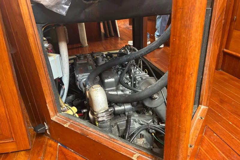Slide: The Image of Engine compartment of a 1980 Hans Christian 43 sailboat, showcasing detailed mechanical components. - 21